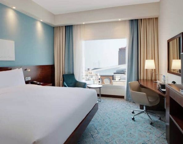 King suite with queen bed, desk, tv, wifi and other amenities at the Hampton by Hilton Dubai al Barsha