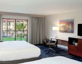 gorgeous queen room with natural light, TV, and work area at DoubleTree by Hilton Hotel Bakersfield.