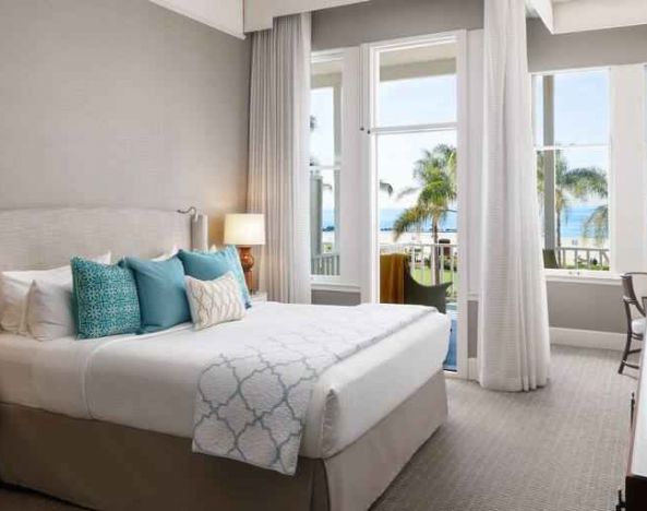 Bright king bedroom with ocean view at the Hotel del Coronado, Curio Collection by Hilton.