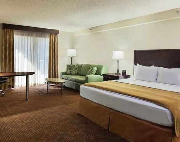 luxurious king suite with work desk and lounge area at DoubleTree by Hilton Hotel Sacramento.