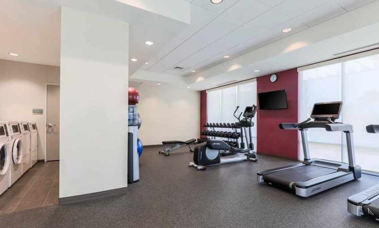 well-equipped fitness center with natural light at Home2 Suites by Hilton West Sacramento.