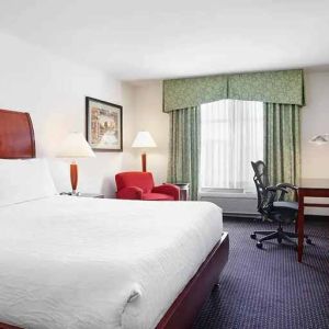 spacious king room with work area and lounge at Hilton Garden Inn Rockville-Gaithersburg.