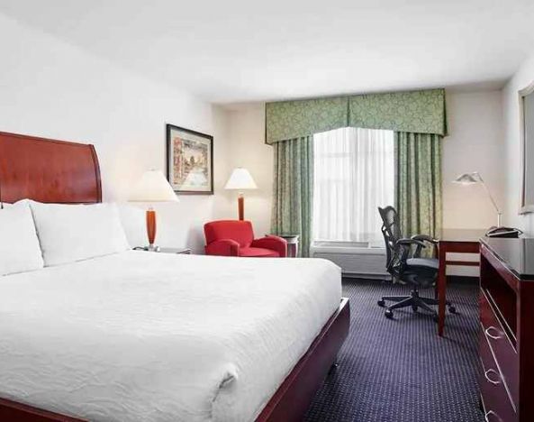 spacious king room with work area and lounge at Hilton Garden Inn Rockville-Gaithersburg.