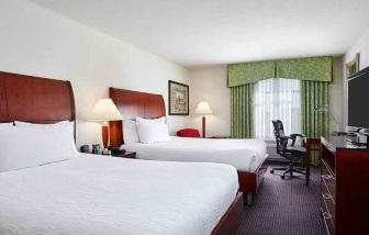 luxurious queen room with TV and work area at Hilton Garden Inn Rockville-Gaithersburg.
