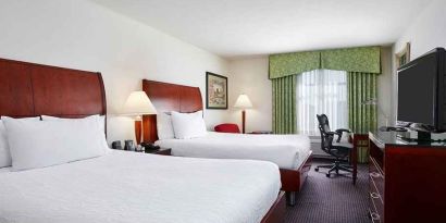 luxurious queen room with TV and work area at Hilton Garden Inn Rockville-Gaithersburg.