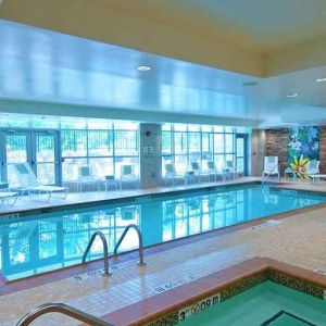 beautiful indoor pool with seating at Hilton Garden Inn Rockville-Gaithersburg.