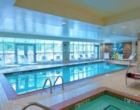beautiful indoor pool with seating at Homewood Suites by Hilton Rockville-Gaithersburg.