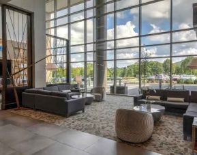 Beautiful lobby area with large windows and lounges perfect as workspace at the Hilton Franklin Cool Springs.