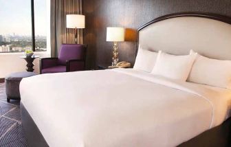Beautiful king bedroom with natural light and city views at Hilton Atlanta.
