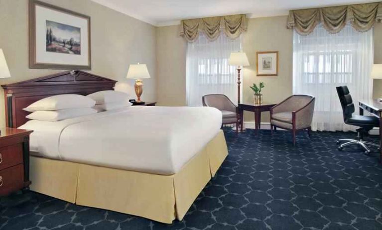 King size bed, sofa and desk in a hotel room at The Drake.