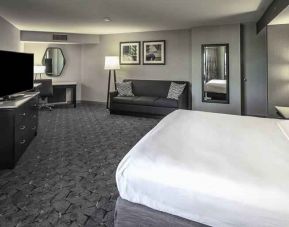 King size bed, sofa and desk in a spacious bedroom at the DoubleTree by Hilton Modesto.