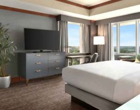 President suite with king size bed, desk and view at the Hilton Baltimore BWI Airport.