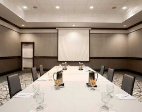 Meeting room with square table at the Embassy Suites by Hilton San Francisco Airport Waterfront.