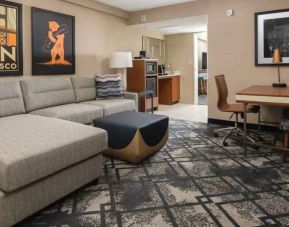 Living room with working station in a king suite at the Embassy Suites by Hilton San Francisco Airport.