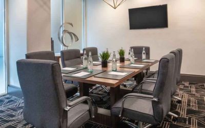 Small meeting room with TV screen at the Embassy Suites by Hilton San Francisco Airport.