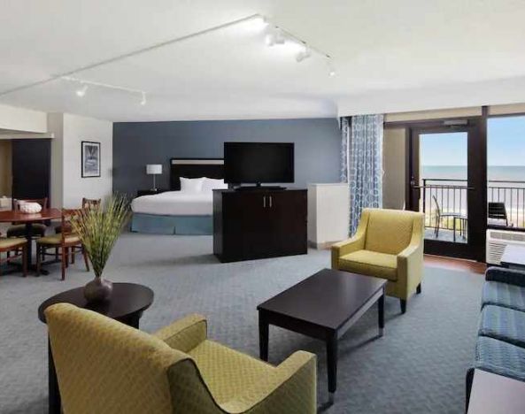 Spacious king suite with king size bed, working station and balcony at the DoubleTree by Hilton Myrtle Beach.
