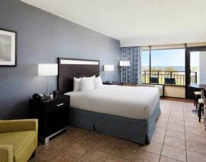 King bedroom with balcony and ocean view at the DoubleTree by Hilton Myrtle Beach.