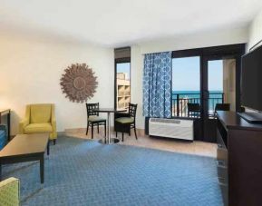 Living area with working station in a king suite at the DoubleTree by Hilton Myrtle Beach.