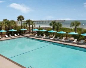 Beautiful outdoor pool area with lounges at the DoubleTree by Hilton Myrtle Beach.
