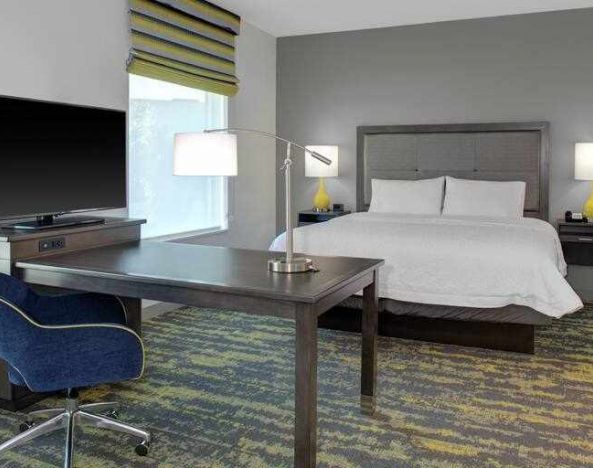 Working station in a king bedroom at the Hampton Inn & Suites by Hilton-Irvine/Orange County Airport.