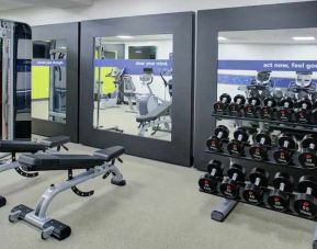 Fitness center with weights at the Hampton Inn & Suites by Hilton-Irvine/Orange County Airport.