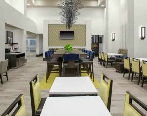 Comfortable dining area perfect as workspace at the Hampton Inn & Suites by Hilton-Irvine/Orange County Airport.