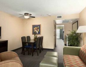 Living area with working station in a king suite at the Embassy Suites by Hilton Miami - International Airport.