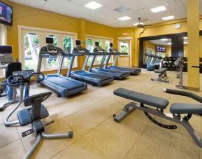 Fitness center with treadmills and machines at the Embassy Suites by Hilton Miami - International Airport.