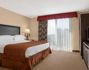 Hotel guestroom with king size bed and window at the Embassy Suites by Hilton Kansas City Plaza.