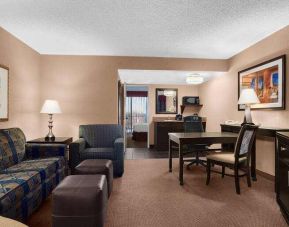 Spacious living area with working station in a king suite at the Embassy Suites by Hilton Kansas City Plaza.