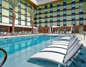 beautiful outdoor pool with seating and sun beds at Hampton Inn & Suites Las Vegas Convention Center.