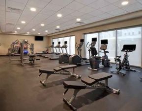 well-equipped fitness center with natural light at Hampton Inn & Suites Las Vegas Convention Center.