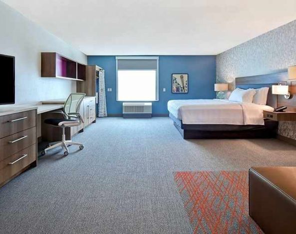 luxurious king suite with work and lounge area at Home2 Suites by Hilton Las Vegas Convention Center.
