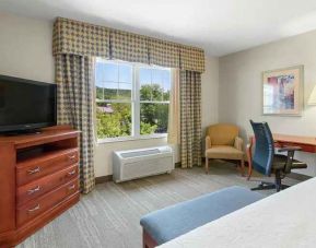 Working station with desk and window in a king bedroom at the Hampton Inn & Suites North Conway.