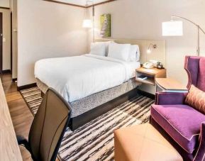 Desk, sofa and king size bed in a king bedroom at the Hilton Garden Inn Minneapolis Airport Mall of America.