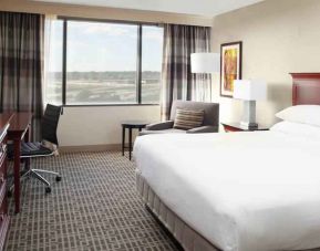 Bright and comfoertable king bedroom with window at the DoubleTree by Hilton Kansas City - Overland Park.