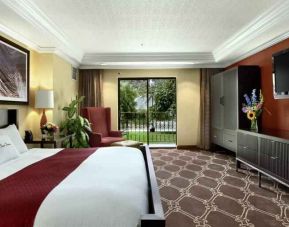 Comfortable king bedroom with window and TVscreen at the DoubleTree by Hilton Durango.