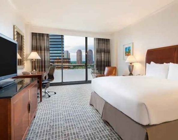 luxurious king suite with work area and city views at Hilton Houston Post Oak by the Galleria.