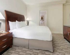 comfortable king bedroom with work desk and TV at Hilton Houston Post Oak by the Galleria.