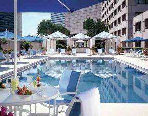 gorgeous outdoor pool with sun beds and seating area at Hilton Houston Post Oak by the Galleria.