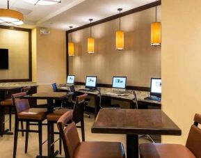 spacious business center with computers, tables, and workspaces for digital nomad work at Hilton Houston Post Oak by the Galleria.