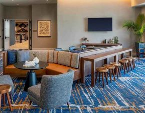A coworking space with lots of natural light at Hilton Garden Inn Austin University.