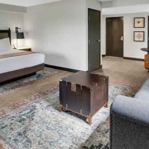 Large guestroom with king size bed and working station at the Estancia del Norte San Antonio, Tapestry Collection.