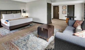 Large guestroom with king size bed and working station at the Estancia del Norte San Antonio, Tapestry Collection.