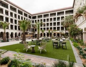 Outdoor workspace with tables and chairs at the Estancia del Norte San Antonio, Tapestry Collection.