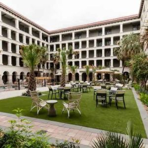 Outdoor workspace with tables and chairs at the Estancia del Norte San Antonio, Tapestry Collection.