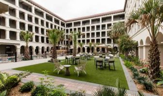 Outdoor workspace with tables and chairs at the Estancia del Norte San Antonio, Tapestry Collection.