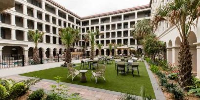 Outdoor workspace with tables and chairs at the Estancia del Norte San Antonio, Tapestry Collection.