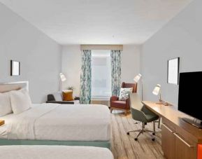 Double queen bedroom with TV screen and desk at the Hilton Garden Inn Houston Medical Center, TX.