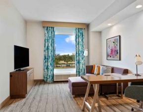 Living room with working station in a hotel room at the Hilton Garden Inn Houston Medical Center, TX.